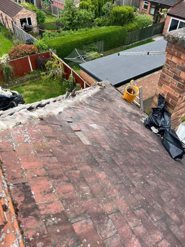 This is a photo of a roof where the hip tiles have been removed, and are just about to be replaced. Works carried out by Clifton Roofing Repairs