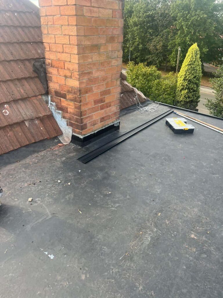 This is a photo of a flat roof which has just been repaired, there is also a chimney stack and some leadwork has also been dressed. Works carried out by Clifton Roofing Repairs